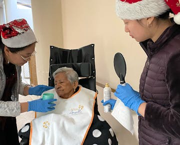 IVHQ volunteers looking after an elder at the Christmas Holiday Experience project in San Jose, Costa Rica