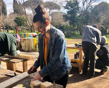 IVHQ volunteer building wood art on the Sustainable Farming project in Rome, Italy