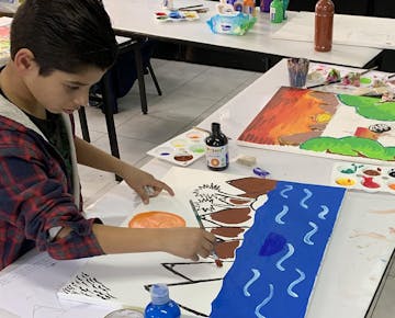 Children painting on the Arts & Music volunteer project in Jordan with IVHQ