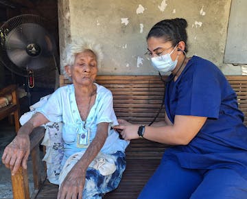 A patient receiving help from IVHQ healthcare volunteer in Philippines