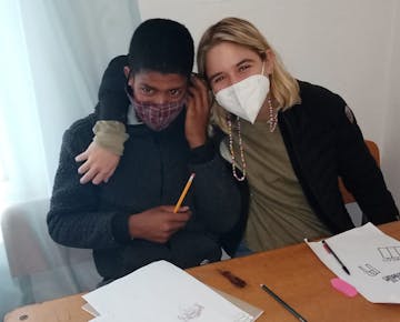 IVHQ volunteer and child on the Teaching project in South Africa